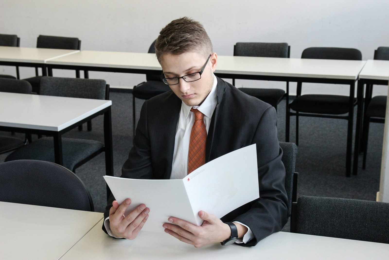 man holding folder in empty room