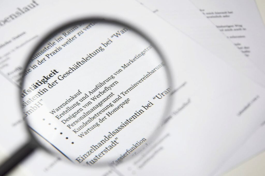 Close-up of a business document text under a magnifying glass.